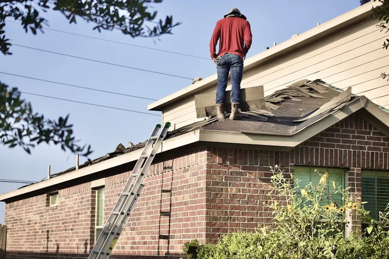 Professional roofer working on a residential roof in North Shirley